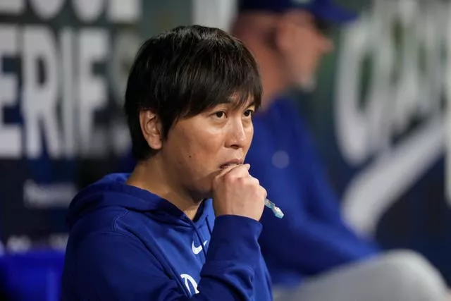 O intérprete do rebatedor designado do Los Angeles Dodgers Shohei Ohtani, Ippei Mizuhara, está no banco de reservas durante um jogo de beisebol no dia de abertura contra o San Diego Padres no Gocheok Sky Dome em Seul, Coreia do Sul 