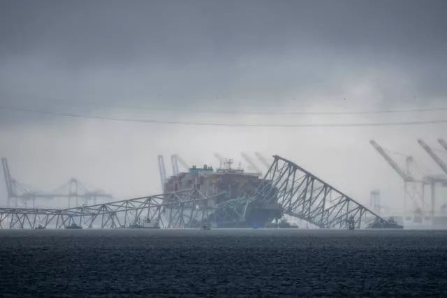 Clouds float over the Patapsco River near the container ship Dali as it rests against wreckage of the Francis Scott Key Bridge
