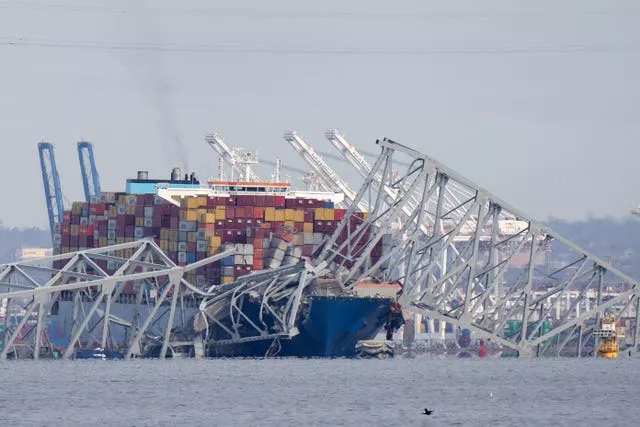 A container ship rests against wreckage of the Francis Scott Key Bridge in Baltimore