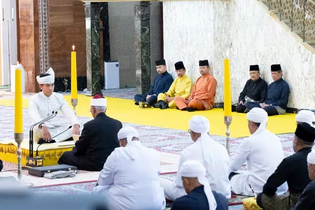 Brunei’s Prince Abdul Mateen, left, sitting during his solemnisation at Sultan Omar Ali Saifuddien Mosque in Bandar Seri Begawan, Brunei