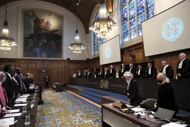 Judges and parties stand at the opening of the hearings at the International Court of Justice in The Hague, Netherlands