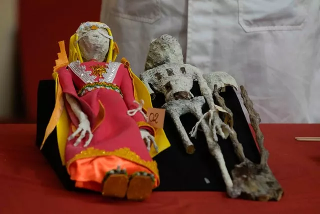 Dolls that were seized by authorities are displayed during a press conference to explain what they are made of at the Archeology Museum in Lima, Peru