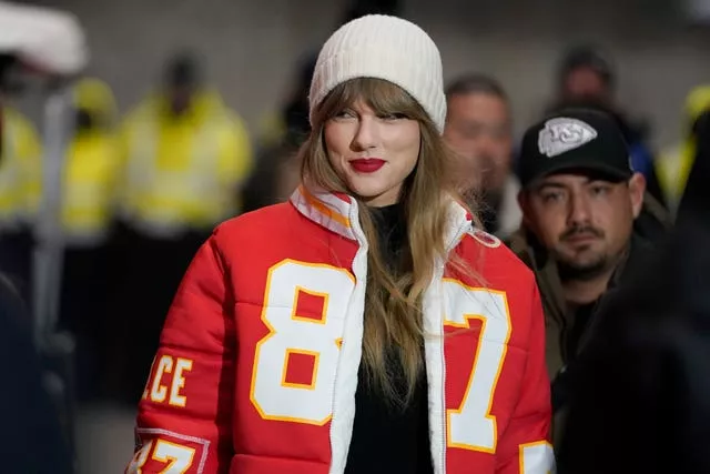 Taylor Swift wearing a Kansas City Chiefs tight end Travis Kelce jacket