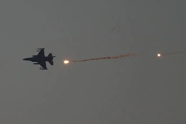 An Israeli fighter jet releases flares as it flies over the Gaza Strip on Tuesday