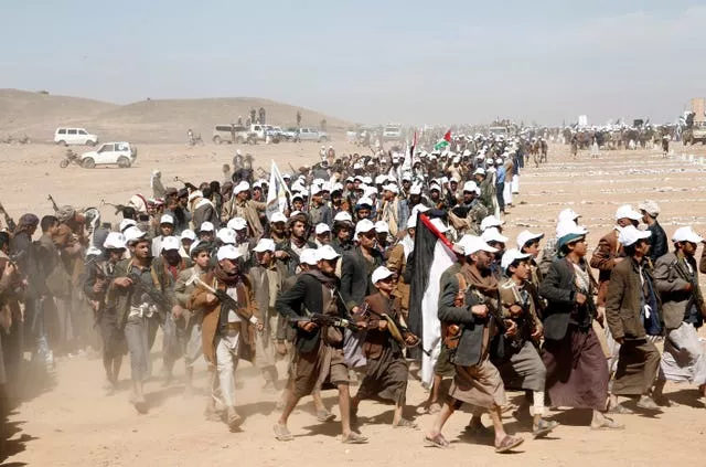 Houthi fighters march during a rally of support for the Palestinians in the Gaza Strip and against the US strikes on Yemen outside Sanaa on Monday