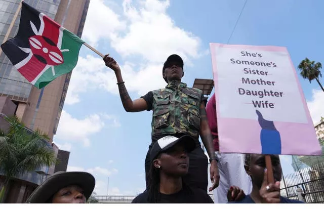 A protester holds a Kenyan flag during a procession to protest against the rising cases of femicide in Nairobi