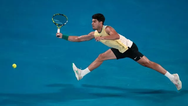 Carlos Alcaraz stretches for a forehand 
