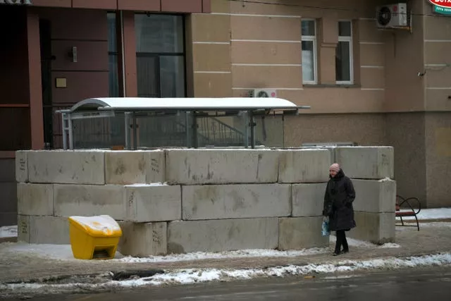 A woman walks past a bus stop in Belgorod, Russia, on Thursday