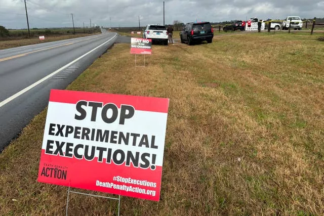 Anti-death penalty signs placed by activists stand along the road heading to Holman Correctional Facility in Atmore, Alabama
