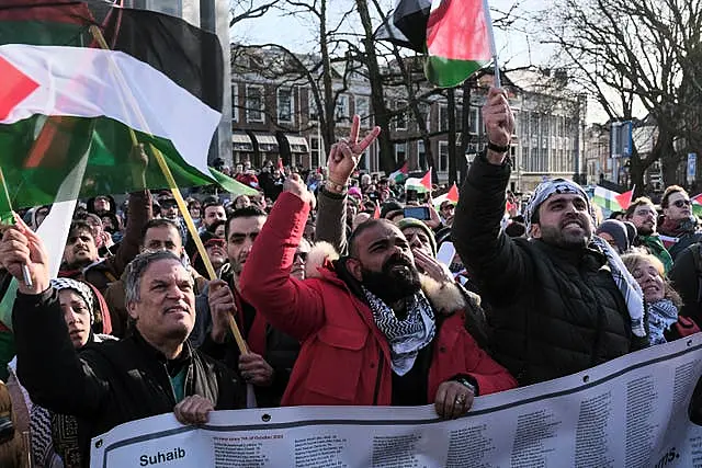 Pro-Palestinian activists react near the International Court of Justice in The Hague, Netherlands