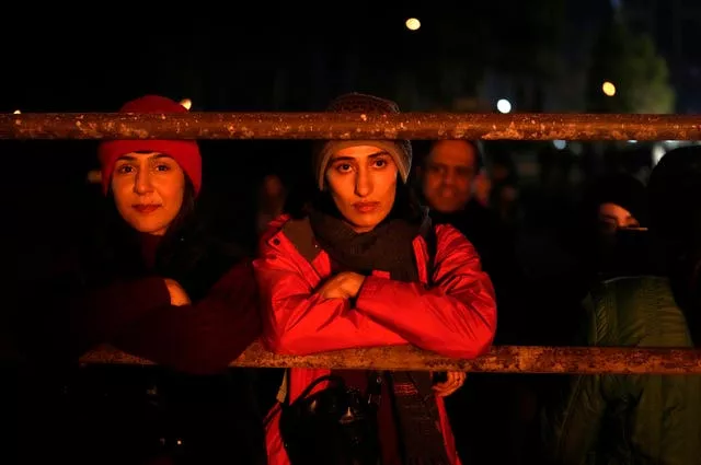 Iranian Zoroastrians look at a giant bonfire