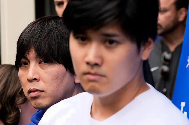 Interpreter Ippei Mizuhara stands next to Japanese baseball star Shohei Ohtani and translates during an interview at Dodger Stadium on February 3 in Los Angeles