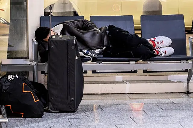 A man rests in a terminal at the airport in Frankfurt, Germany