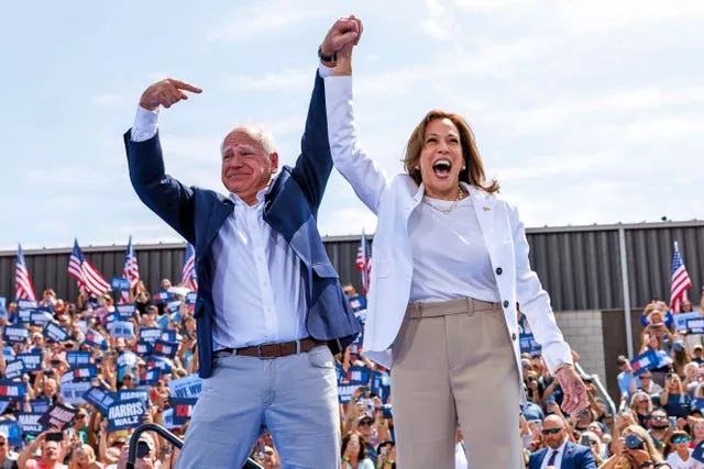 Democratic presidential nominee Kamala Harris is welcomed by running mate Tim Walz (Kerem Yücel/Minnesota Public Radio via AP)