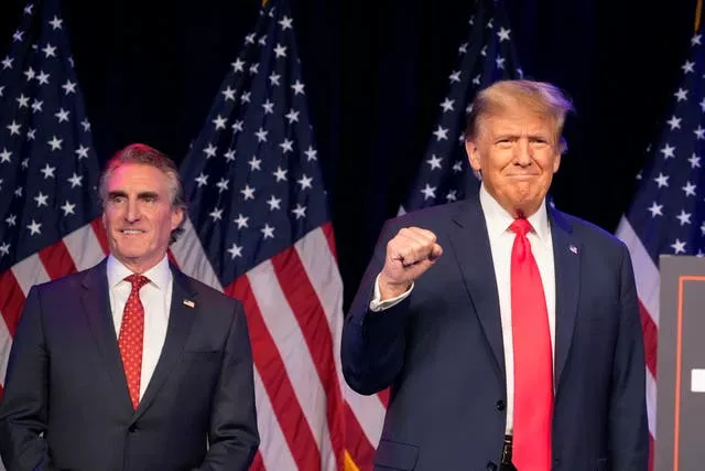 Two men in blue jackets and red ties