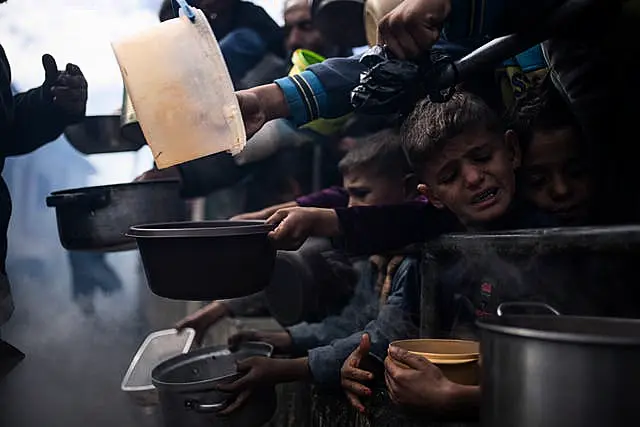 Palestinians line up for food in Rafah