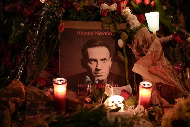 Flowers and candles are laid around a photo of Russian opposition leader Alexei Navalny during a rally to commemorate him, at Rome’s Piazza del Campidoglio city council square