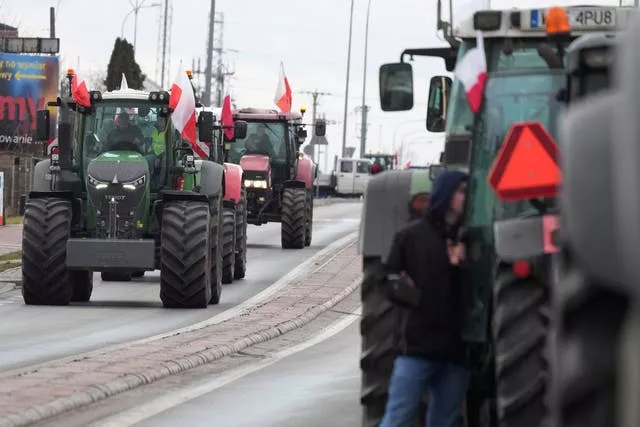 Polish farmers drive tractors in a convoy during a protest in Minsk Mazowiecki, Poland (Czarek Sokolowski/AP)