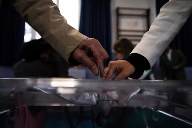 Voters' hands casting ballots