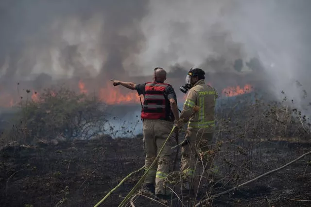 Firefighters surrounded by smoke