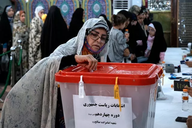 A woman casts her vote for the presidential election