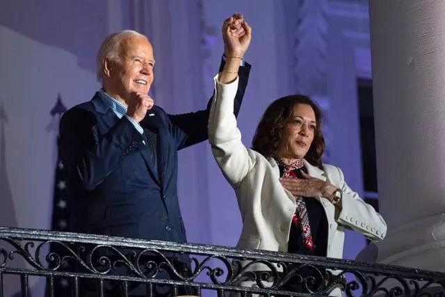 Joe Biden raises the hand of Kamala Harris at the White House