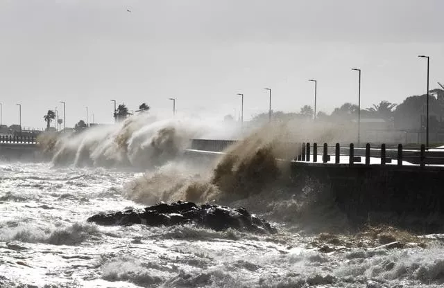 Waves crash over the promenade 