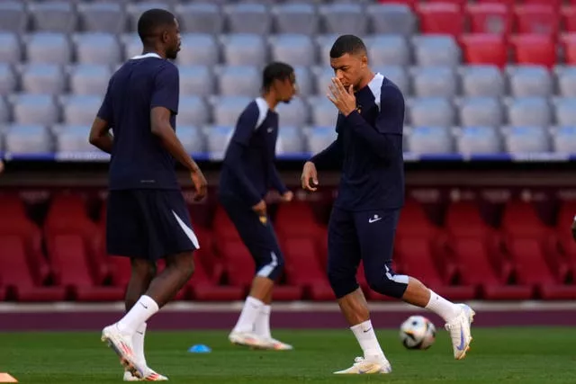 Mbappe feels his nose during France training 