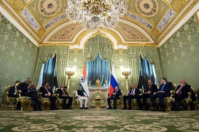 Indian Prime Minister Narendra Modi and Russian President Vladimir Putin speak during a meeting at the Kremlin 