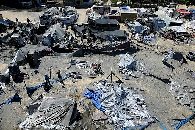 Palestinians inspect the damage at a site in Khan Younis in the southern Gaza Strip after an Israeli bombardment