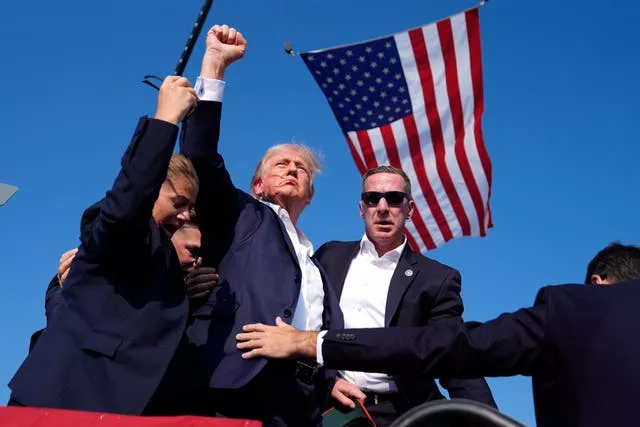 Donald Trump raises his fist after the shooting in Pennsylvania