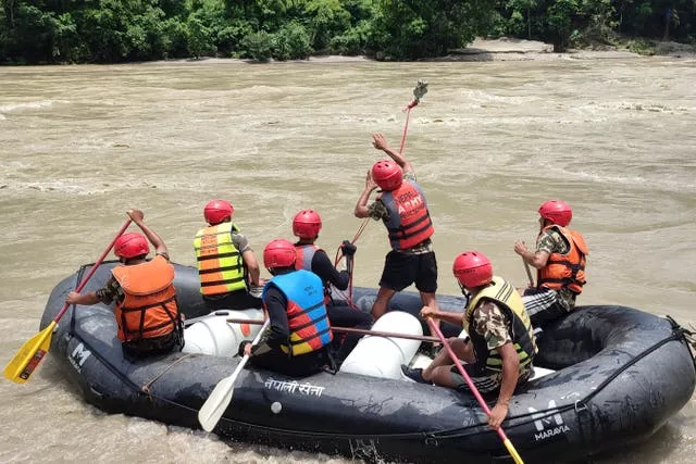 Nepal army personnel cary out a search operation on a boat