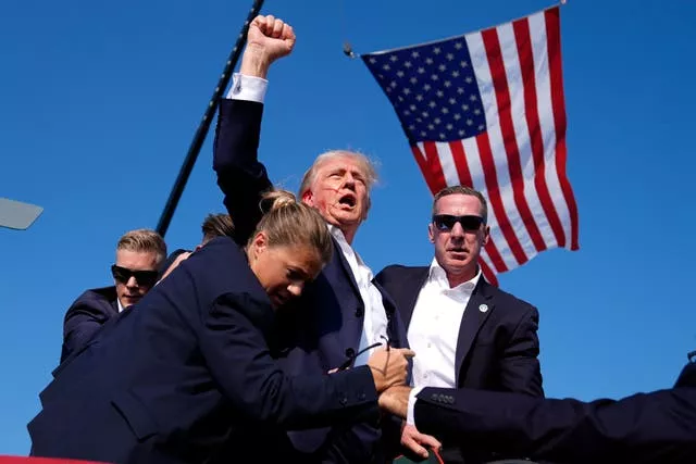 Republican presidential candidate Donald Trump is surrounded by US Secret Service agents (Evan Vucci/AP)