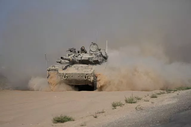 An Israeli tank manoeuvres near the Israel-Gaza border