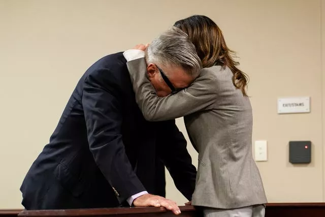 Alec Baldwin puts his head on his wife Hilaria's shoulder