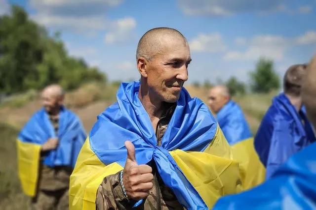 A Ukrainian prisoner of war shows a thumbs up sign as he poses for a photo 