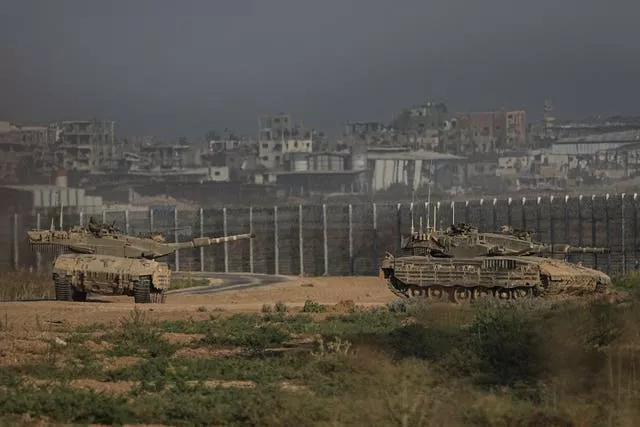 Israeli tanks stand near the Israel-Gaza border 