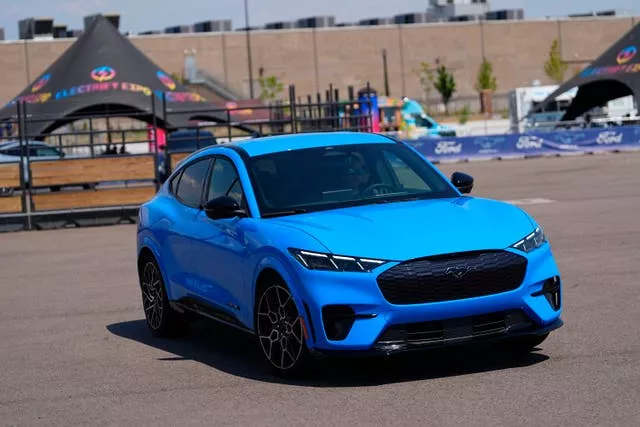 A motorist puts an electric 2024 Ford Mustang Mach-E through its paces on a test track at the Electrify Expo in north Denver last month