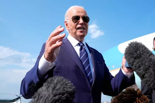 Joe Biden wearing sunglasses next to plane