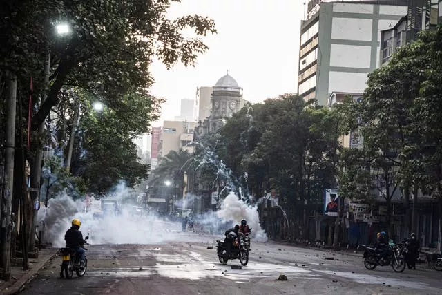 Police officers fire tear gas during a protest in Nairobi 