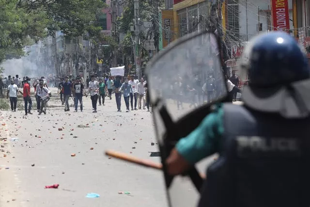 Students face riot police in Dhaka