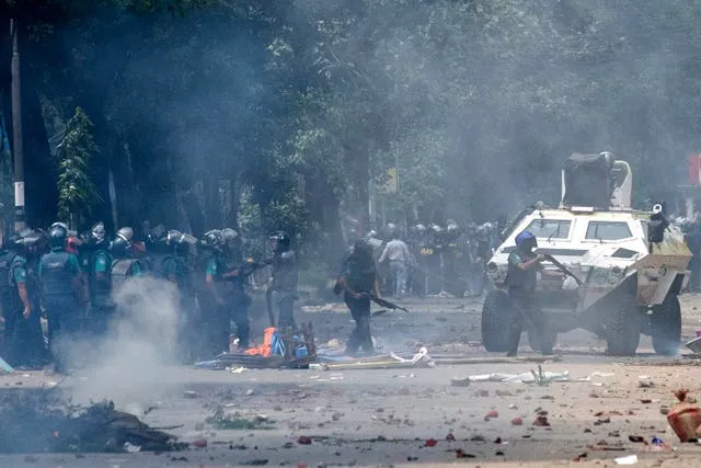 Police fire tear gas shells to disperse students protesting over a controversial quota system for government job applicants (Rajib Dhar/AP)