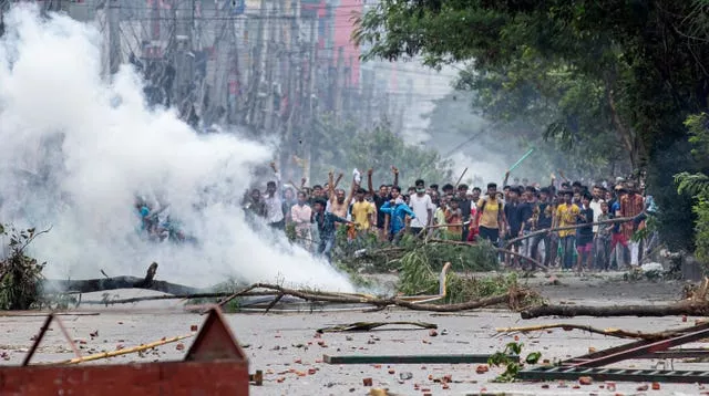 Group of protesters, with smoke and debris in the foreground