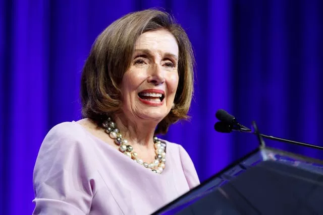 Head and shoulders of Nancy Pelosi speaking at a lectern