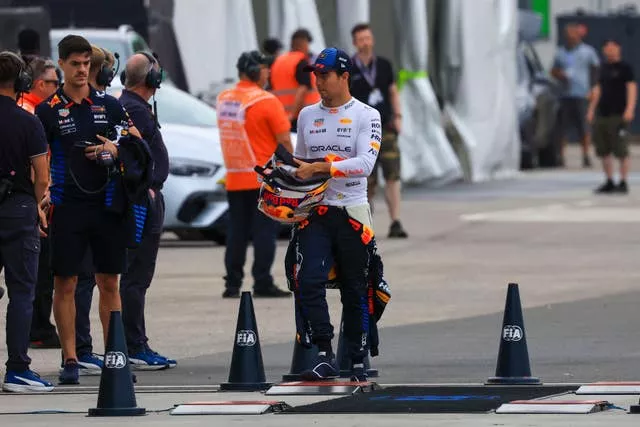 Sergio Perez walks back to the pits