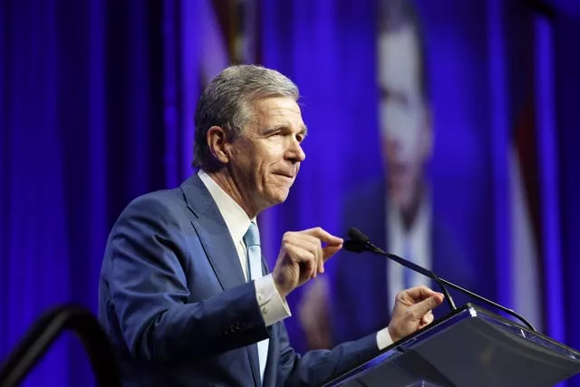 Roy Cooper speaking into a microphone