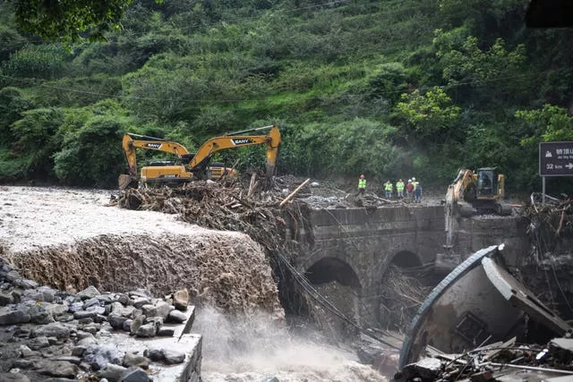 excavators remove debris from a bridge