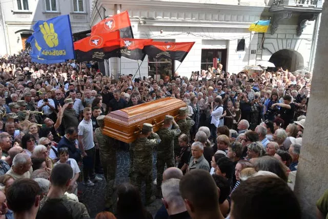 Crowds surround the coffin of Iryna Farion during a funeral ceremony in Lviv