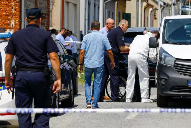 Police and forensics gather near the crime scene in Daruvar