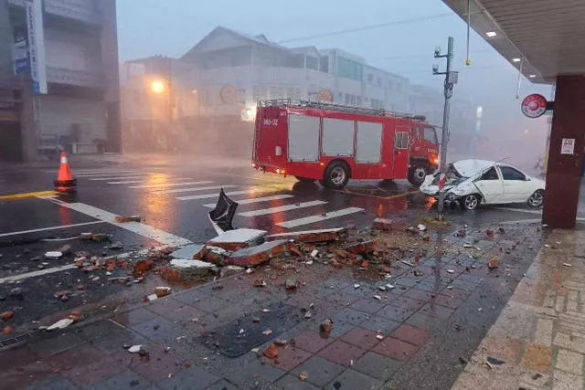 A car is hit by falling walls